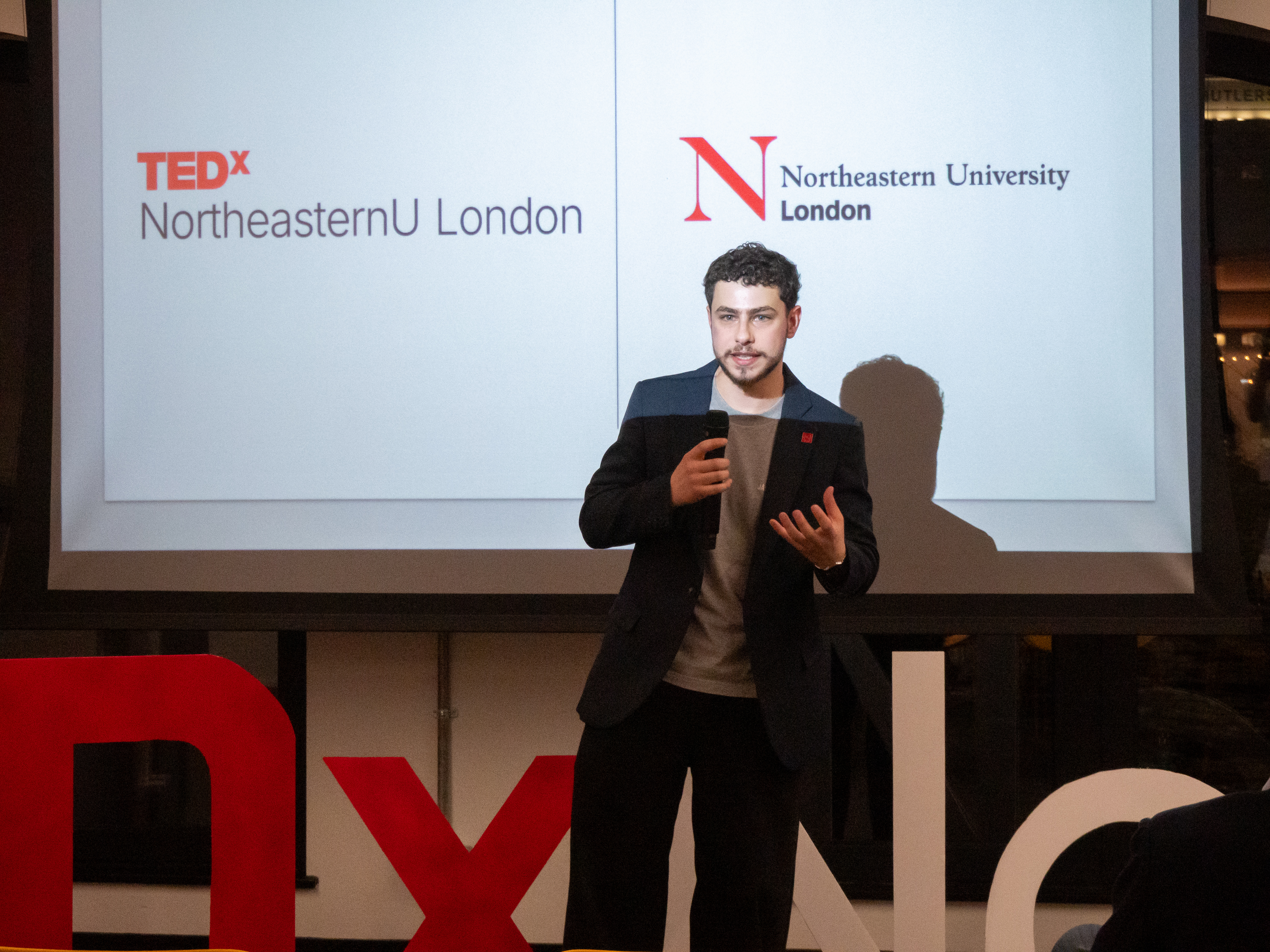 Speaker on stage at TEDxNortheasternU London
