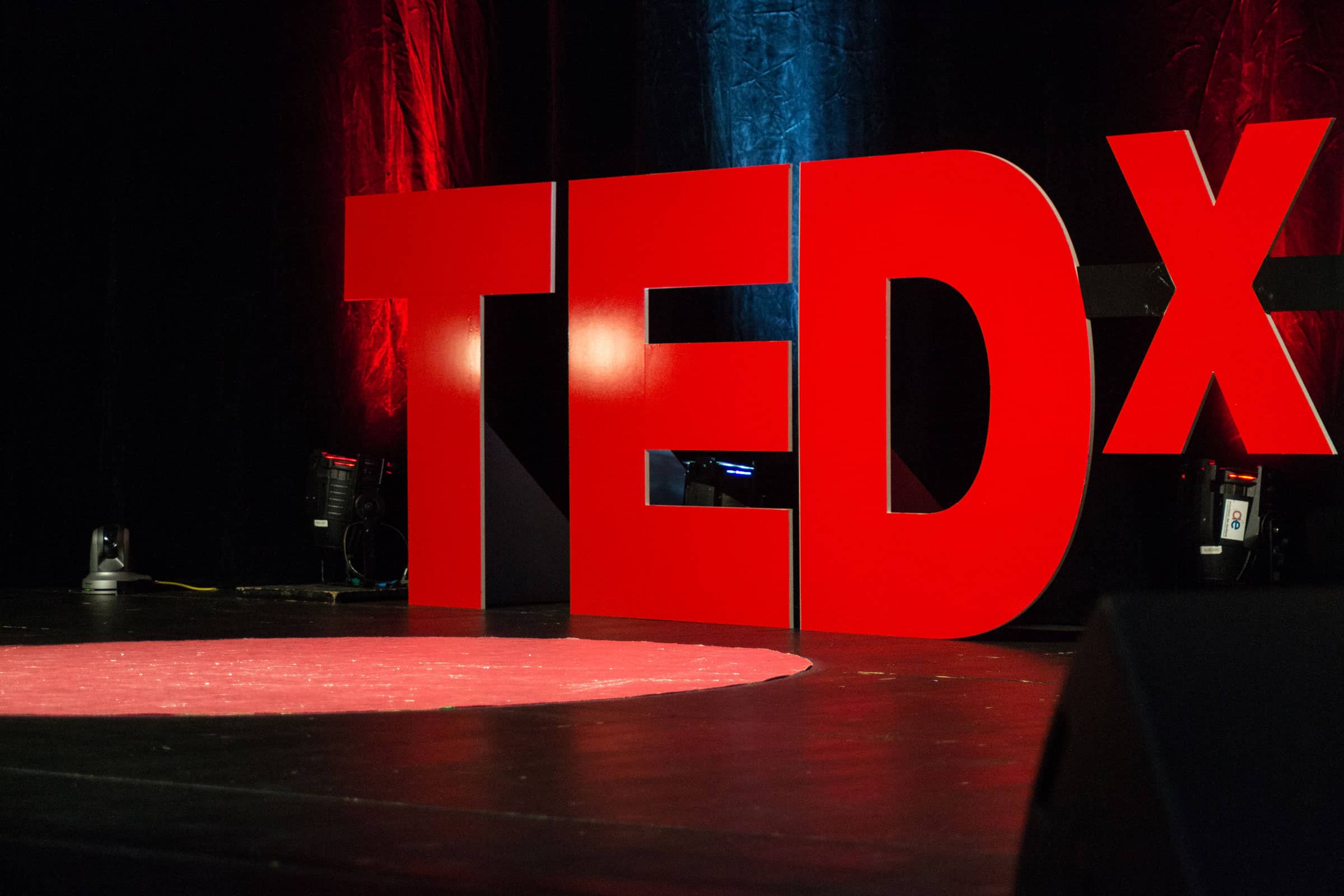 TEDx stage with large red letters